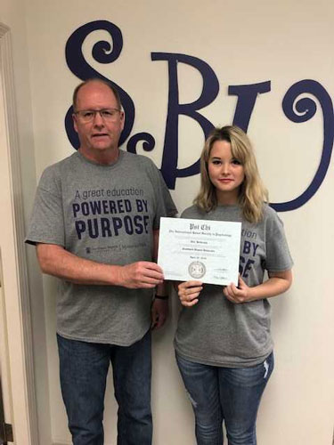 SBU-MTV psychology professor Phil Rohrer presents Allie Hickerson with her Psi Chi induction.