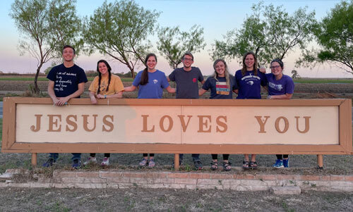 SBU's Border Perspectives mission team stands behind a sign.