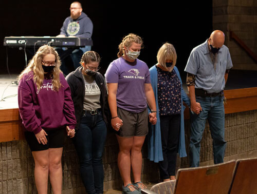 Members of mission team pray.