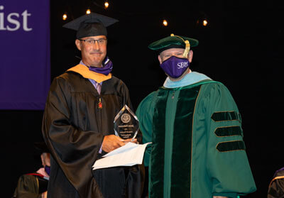 Jason Halverson receives Orien B. Hendrex Distinguished Teacher Award.