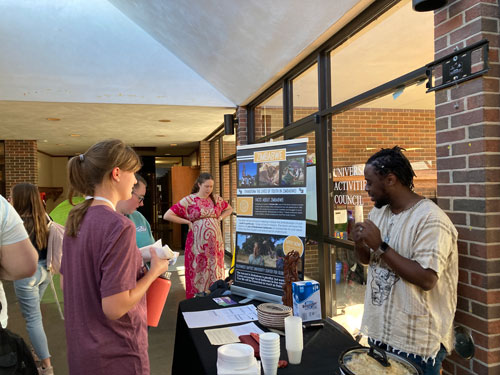 People gather around Zimbabwe table
