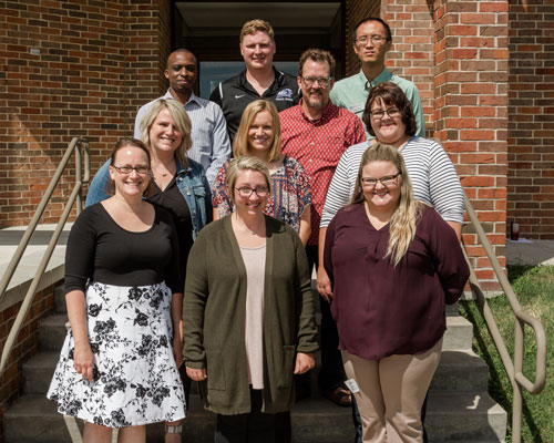 New faculty on steps to admin building