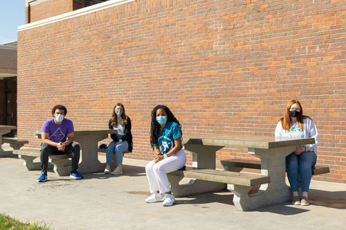 Students sit at new picnic tables