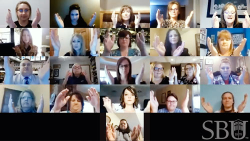 Faculty bless the hands of nursing graduates