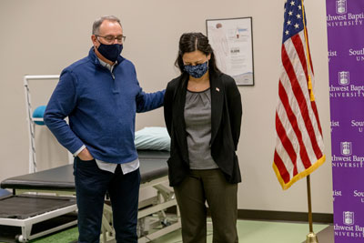 DPT professor prays over DPT alumnae