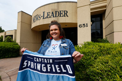 Rebecca Weber holds her Captain Springfield banner