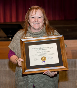 Dr. Renay McCarley holds her Life Beautiful Award