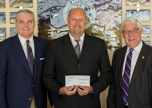 Terry Lockhart, of Windstream, presents a donation to SBU President Dr. Pat Taylor (right) and SBU President-Elect Dr. Eric A. Turner.