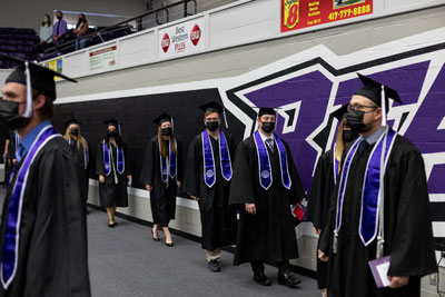 Graduates walk in for commencement ceremony