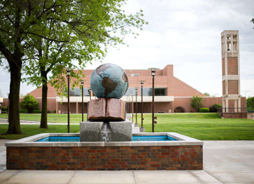 Bolivar campus forum with globe water sculpture in foreground