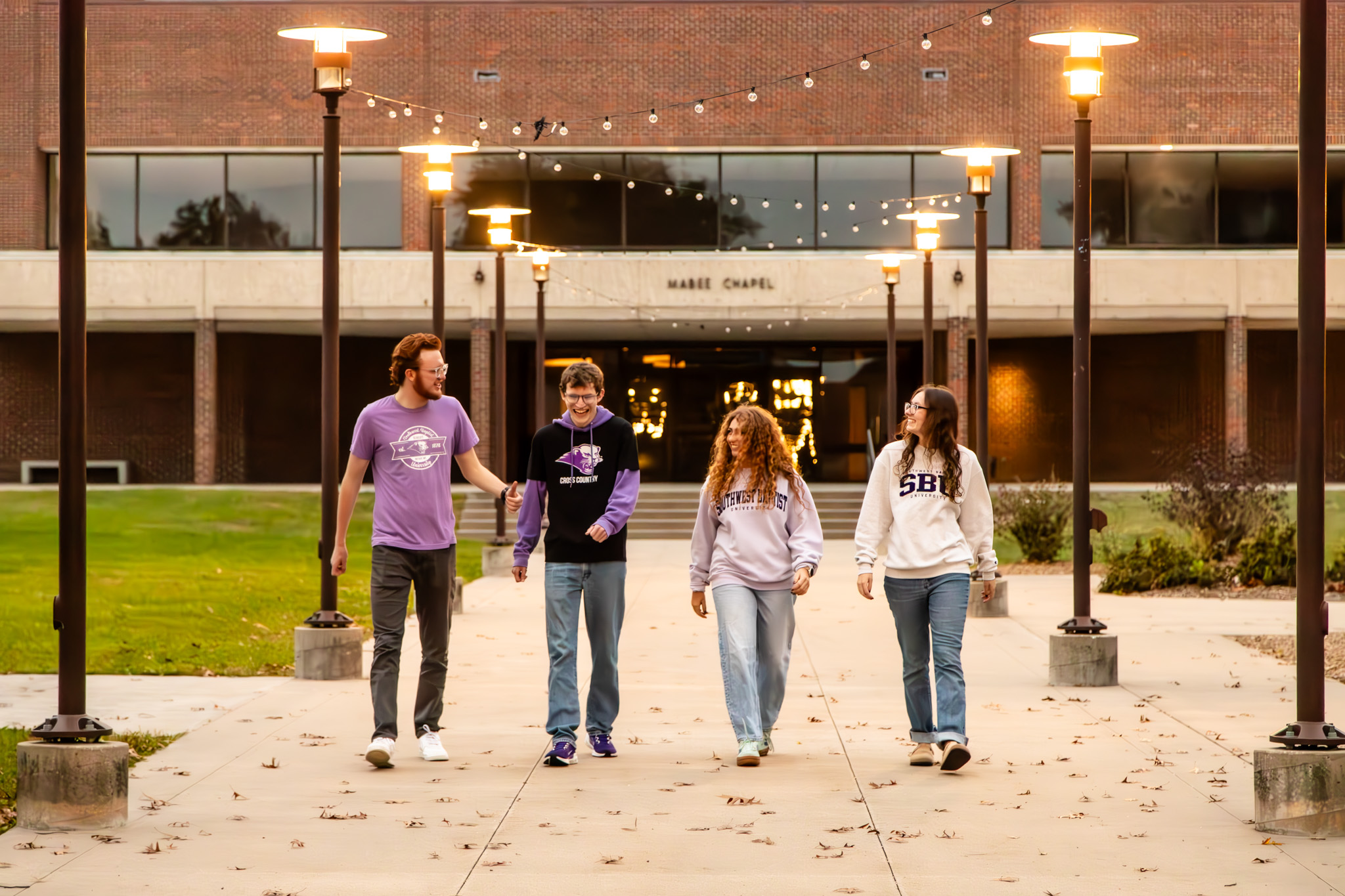 two girls hold poster board sign that says welcome to S-B-U