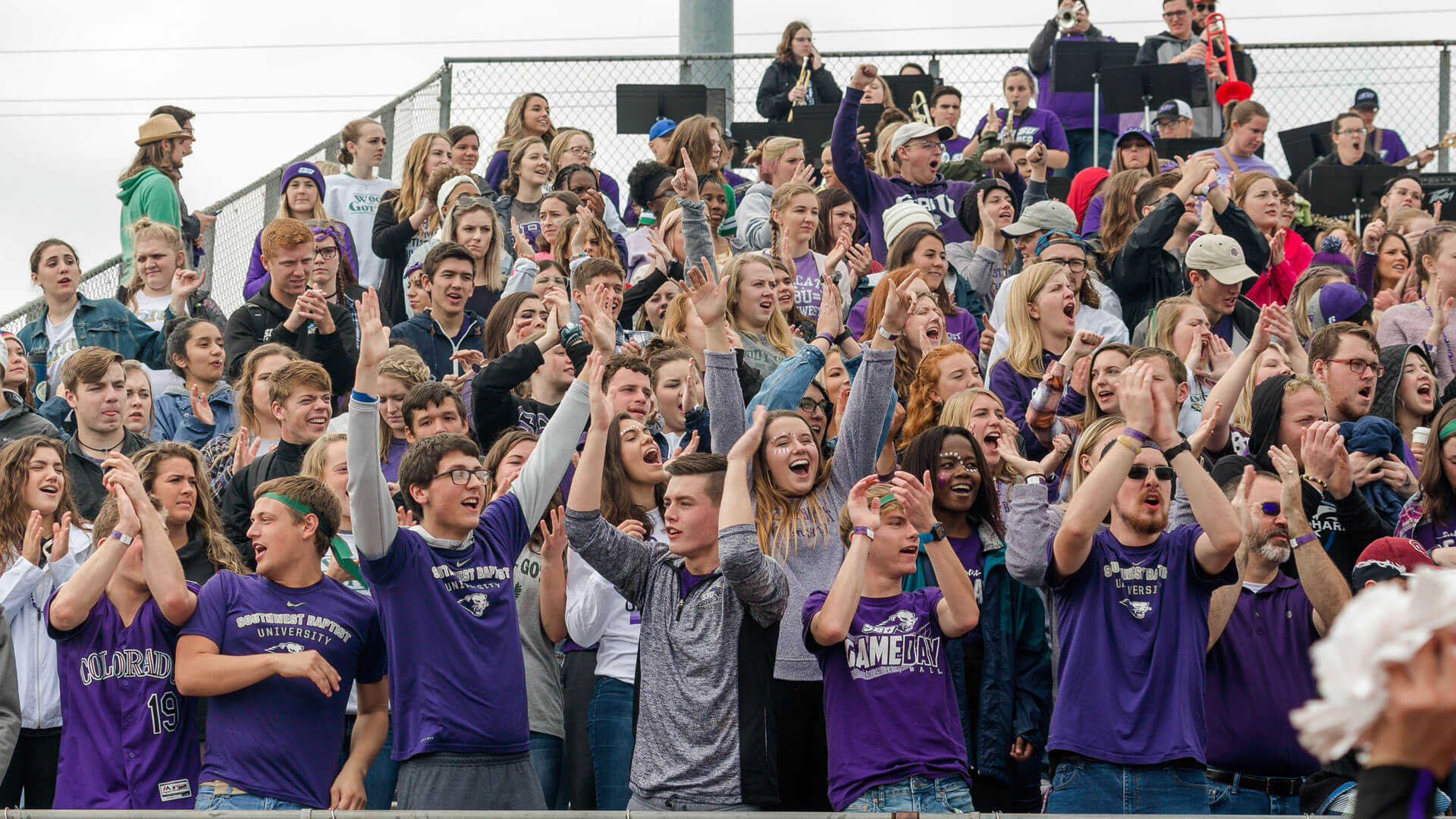 student section cheering at football game
