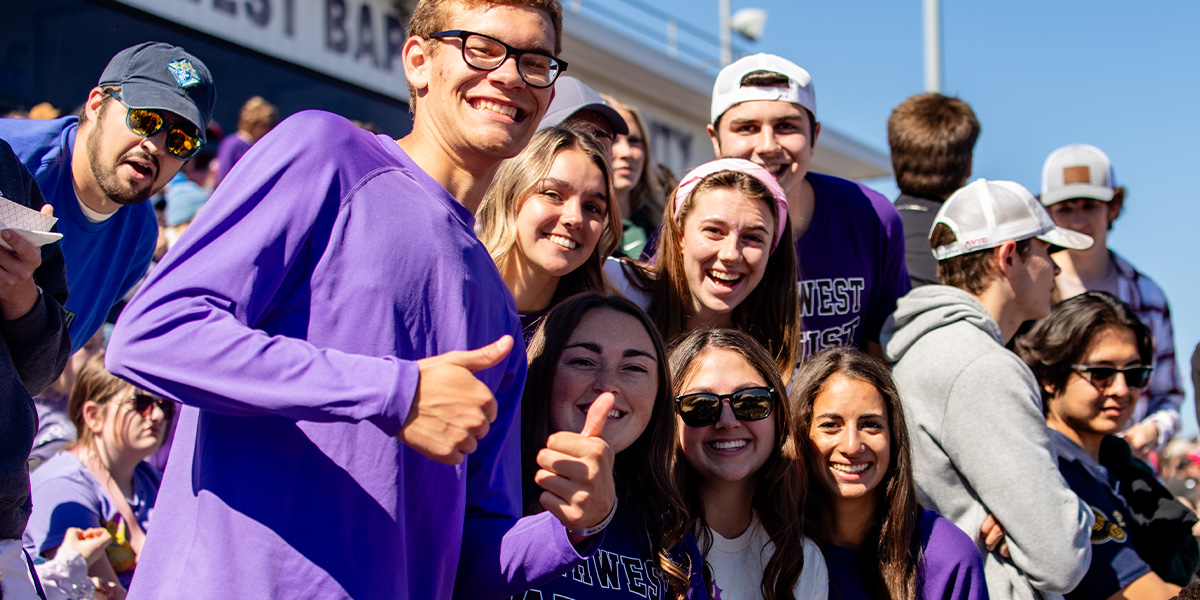 students gathered together at SBU football game
