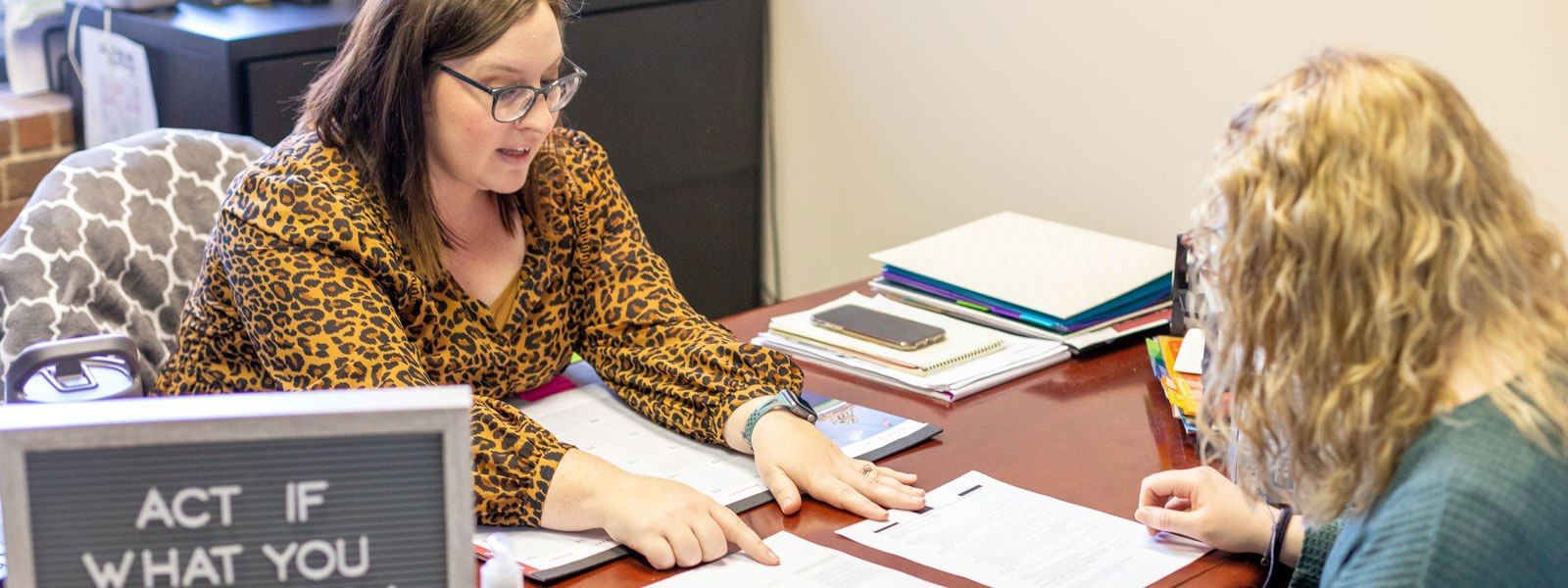 student interacts with professional at career fair