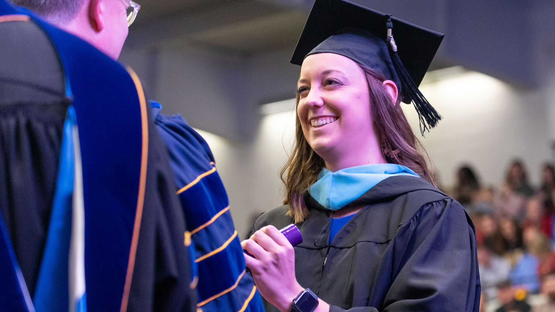 master's in education graduate receives diploma