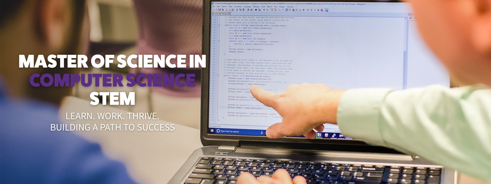 hands at computer working on school work