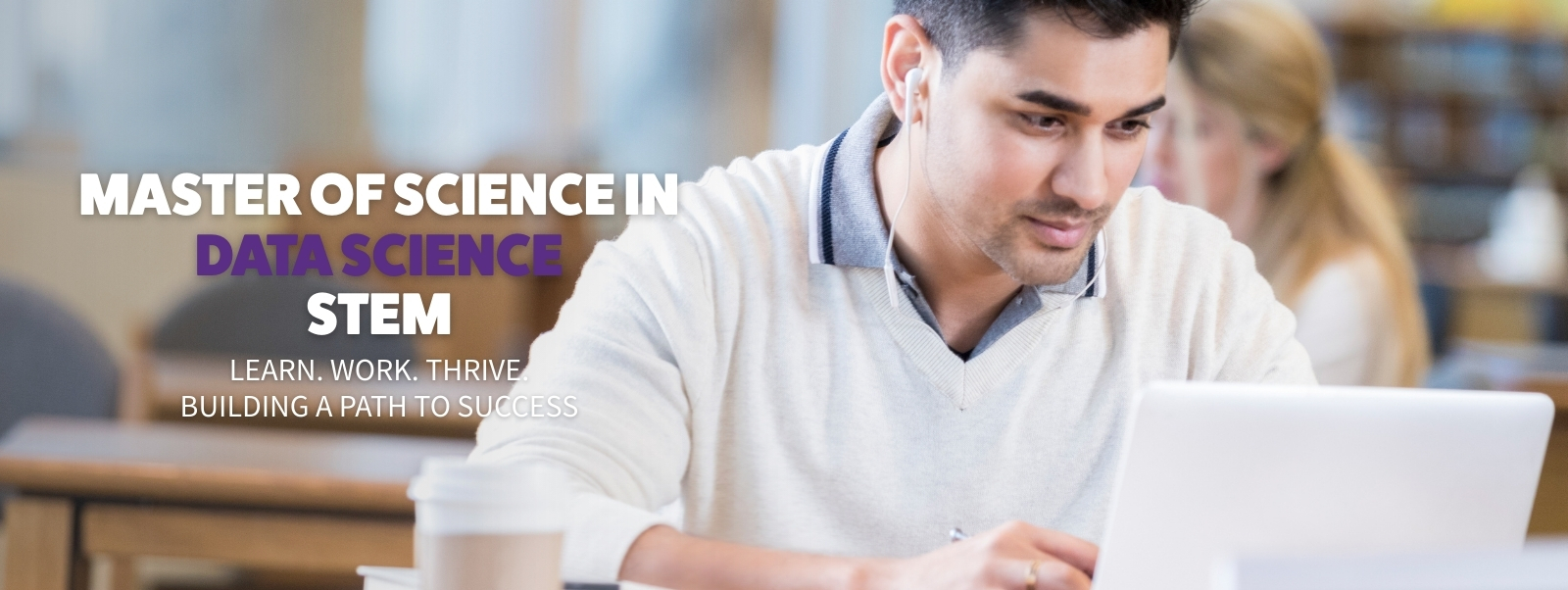 student working on computer in coffee shop