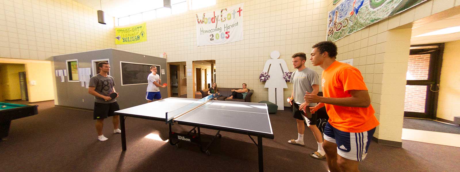 students playing ping-pong in dorm lobby