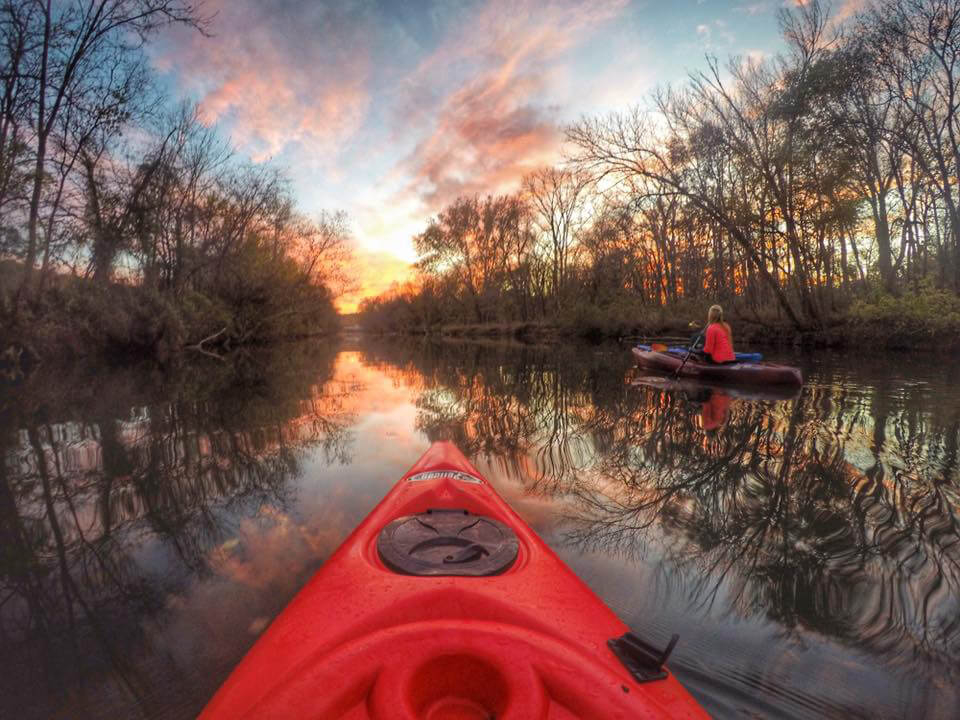 kayak on lake at sunset