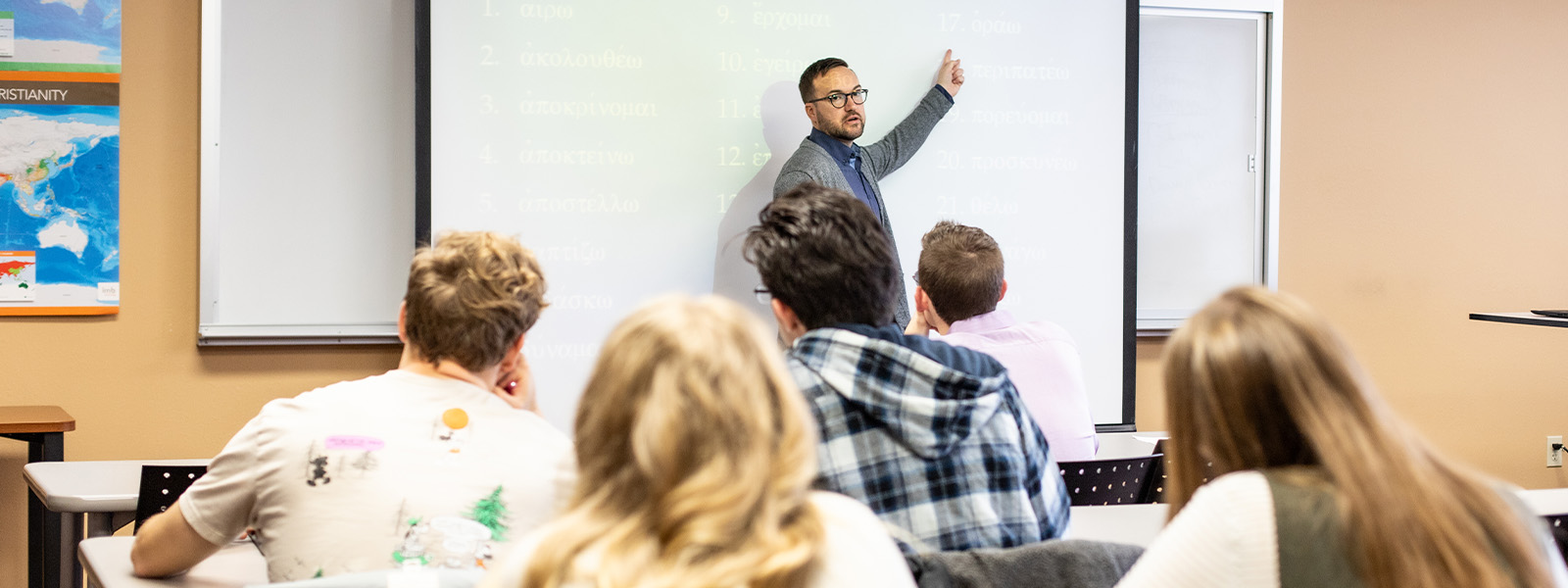 student reading Bible in class