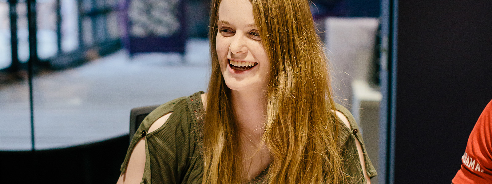 professor standing in lobby talking with group of students