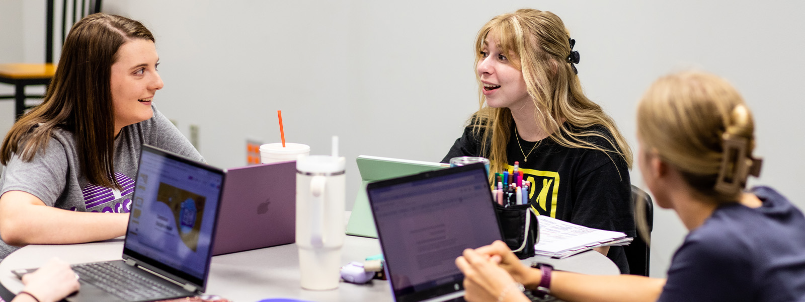 group of communication students talking and laughing