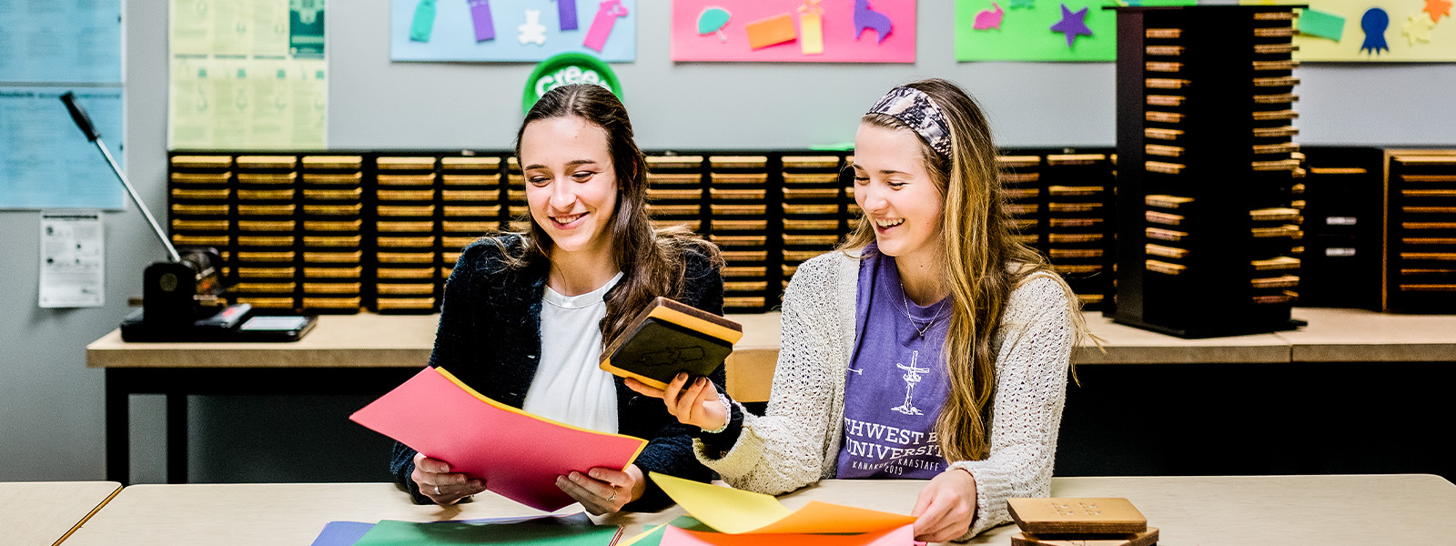 female college student reads book to young boy