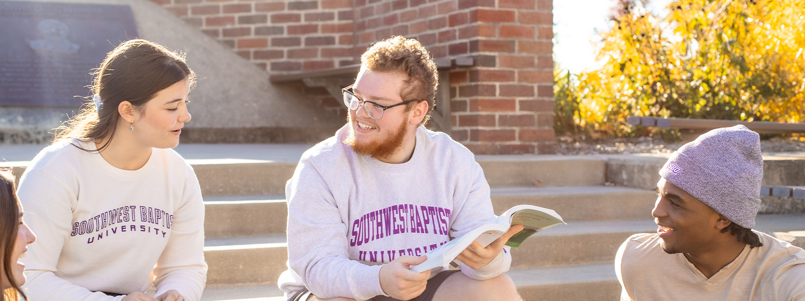 students browse shelves in library