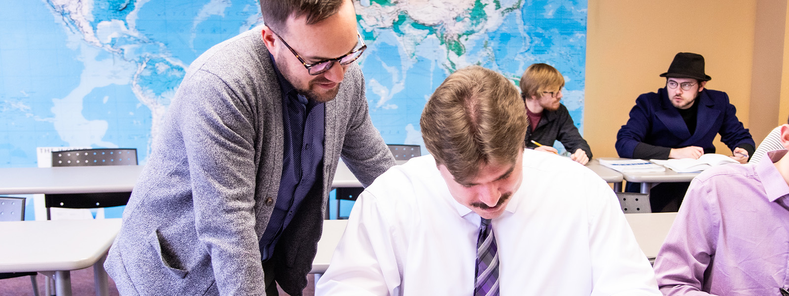 professor offering help to a global education student