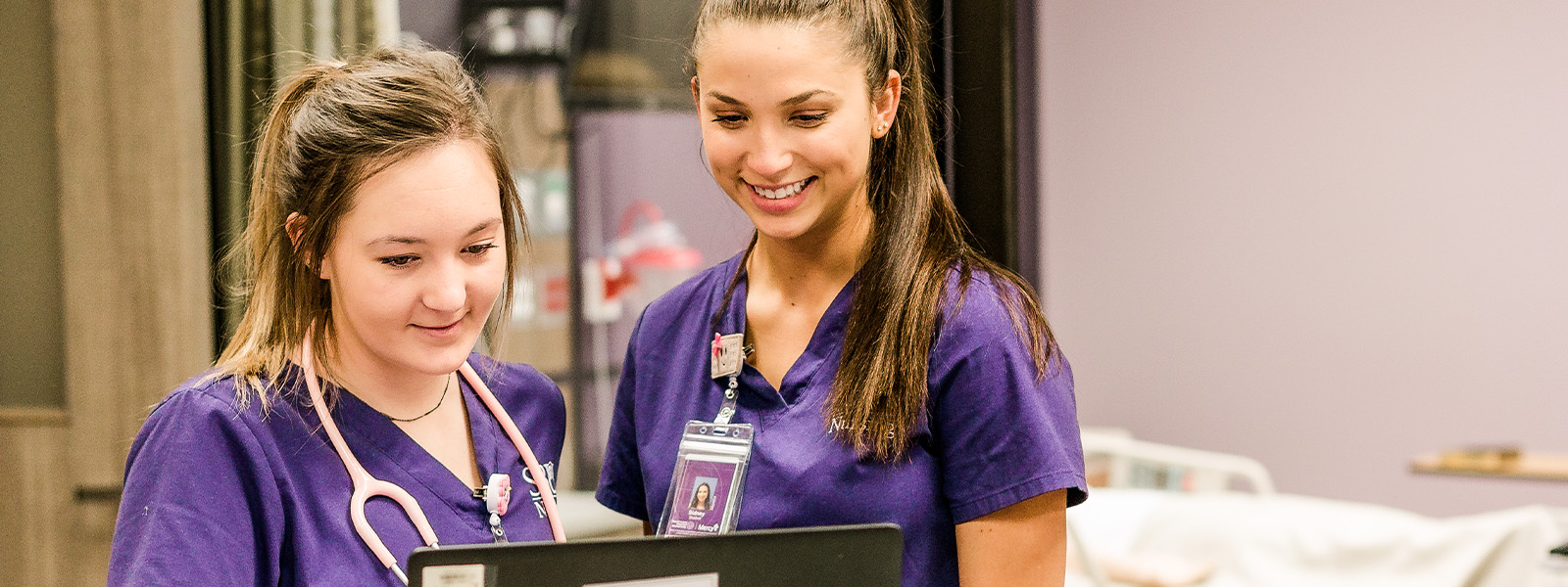 nursing students examine human anatomy models