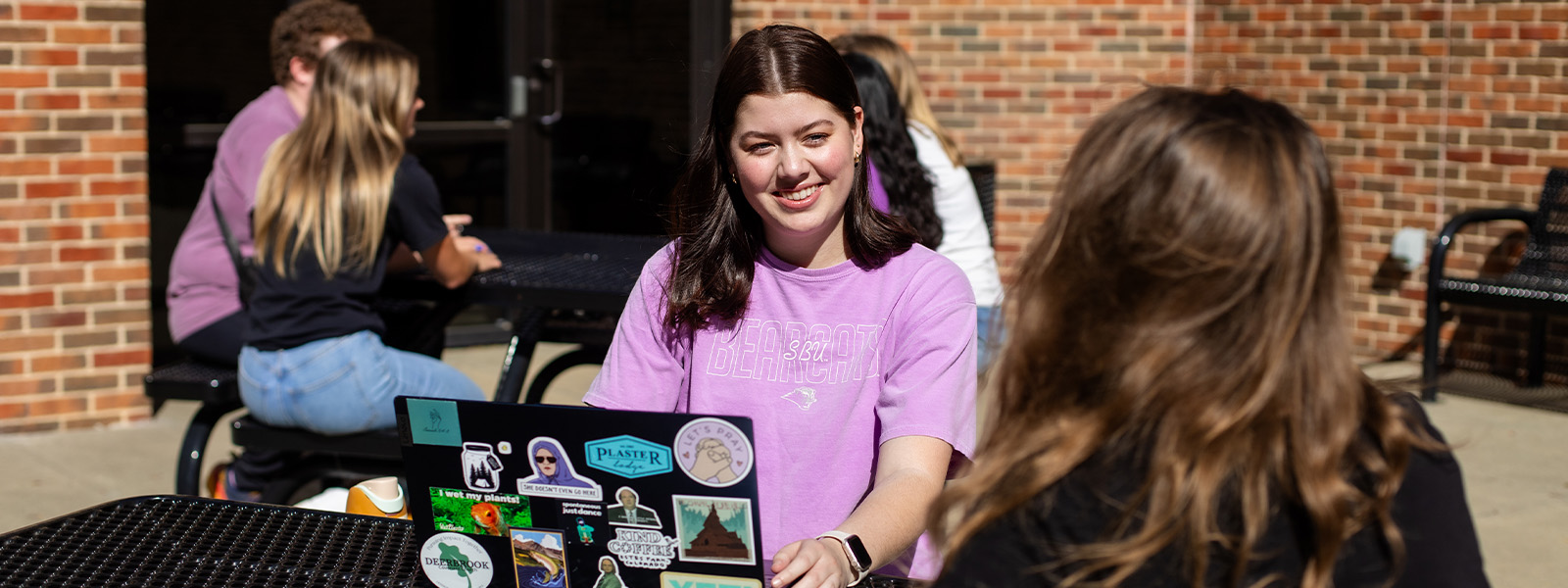 students studying outside working on homework