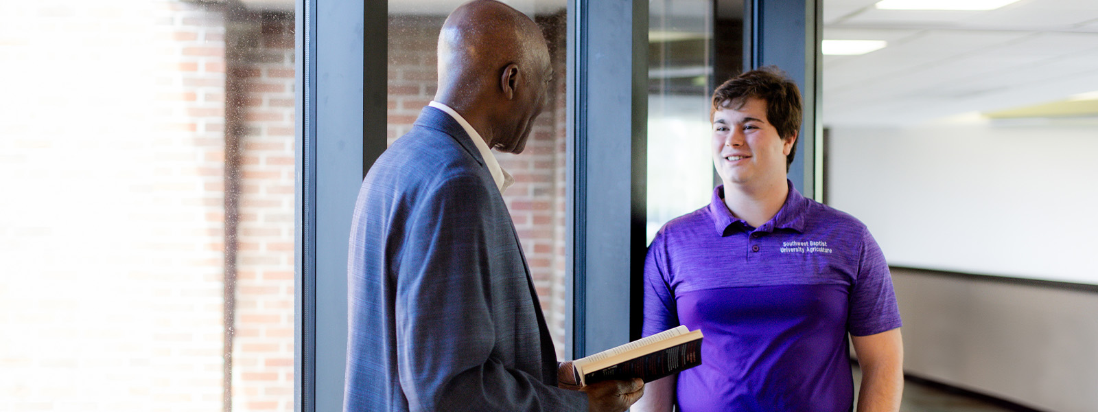 student giving presentation next to map on computer screen