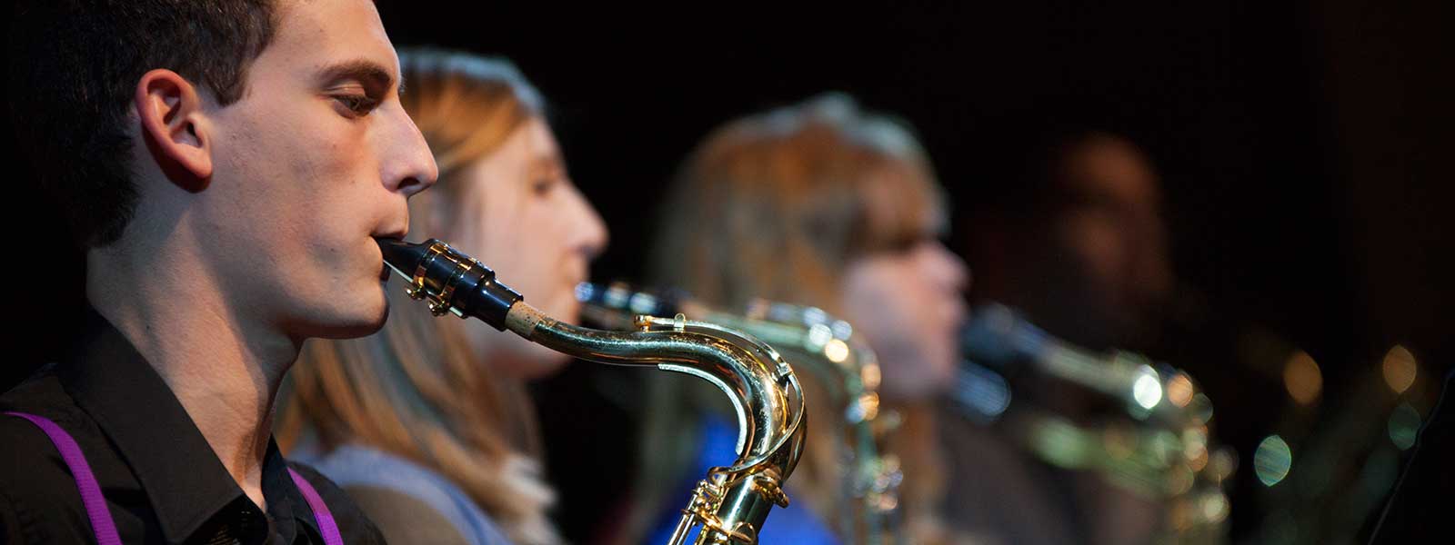 student playing saxophone in jazz band