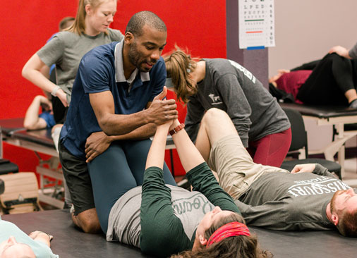 physical therapy students practice exercises