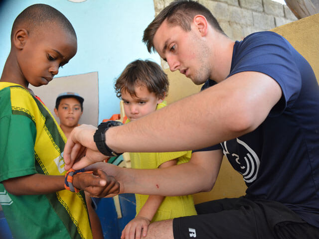 students working with kids on mission trip