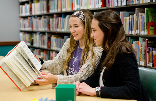 girls studying in library