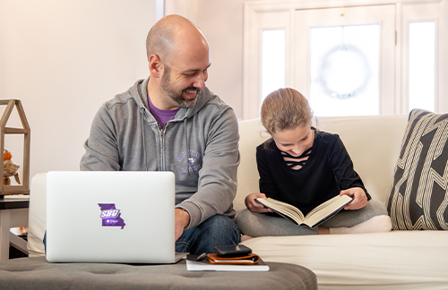 dad and daughter working on homework together