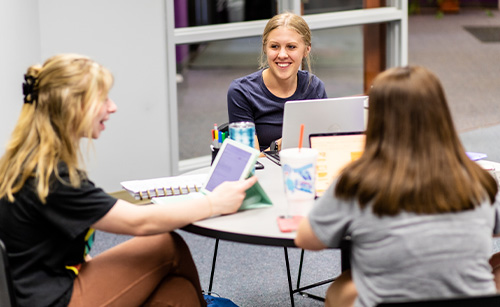 Social Awareness Club students gathered together at a table