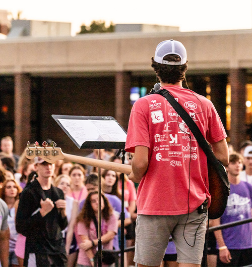 Students gathered together in worship on SBU campus lawn students leading worship on SBU lawn
