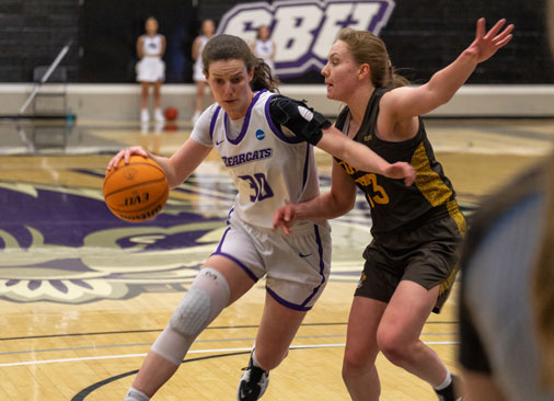 S-B-U female basketball player drives basketball to the hoop